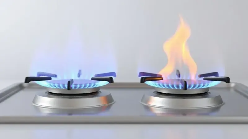 Ilustração digital comparativa mostrando a diferença visual entre uma chama de fogão azul estável e uma chama amarela com fuligem.