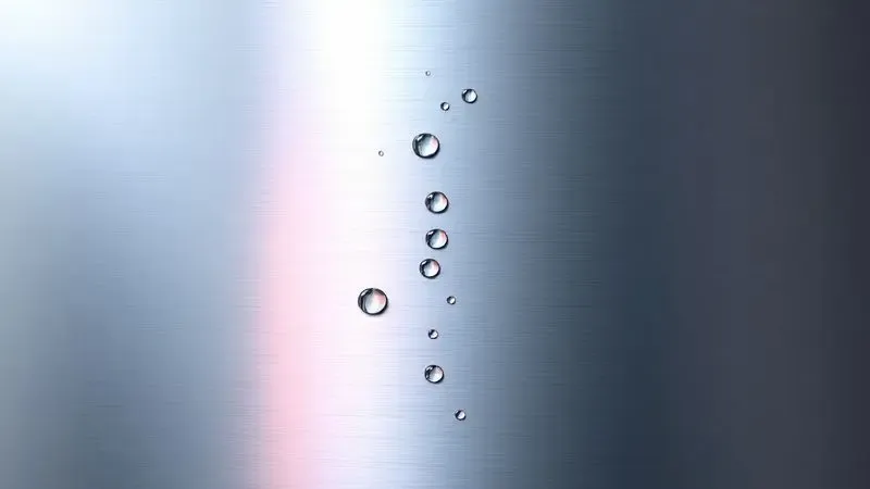 Ilustração conceitual de uma superfície de aço inox com manchas de calor e marcas de água em close-up.